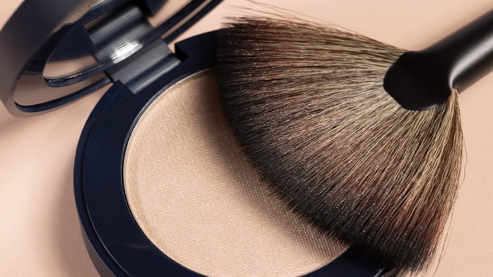 A professional makeup brush with compact powder